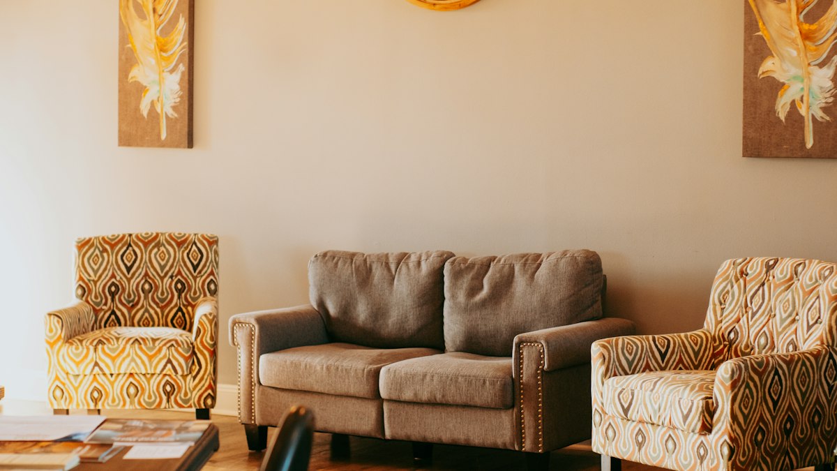 A quiet room with two armchairs and a sofa