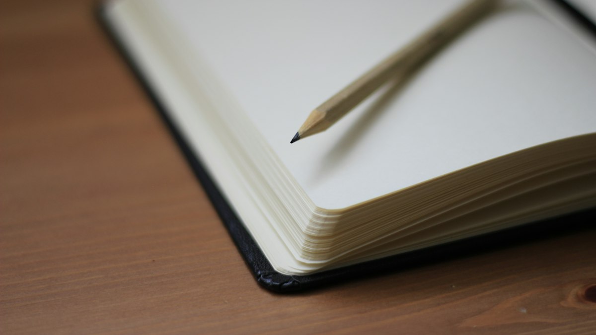 Shallow focus photography of pencil on book
